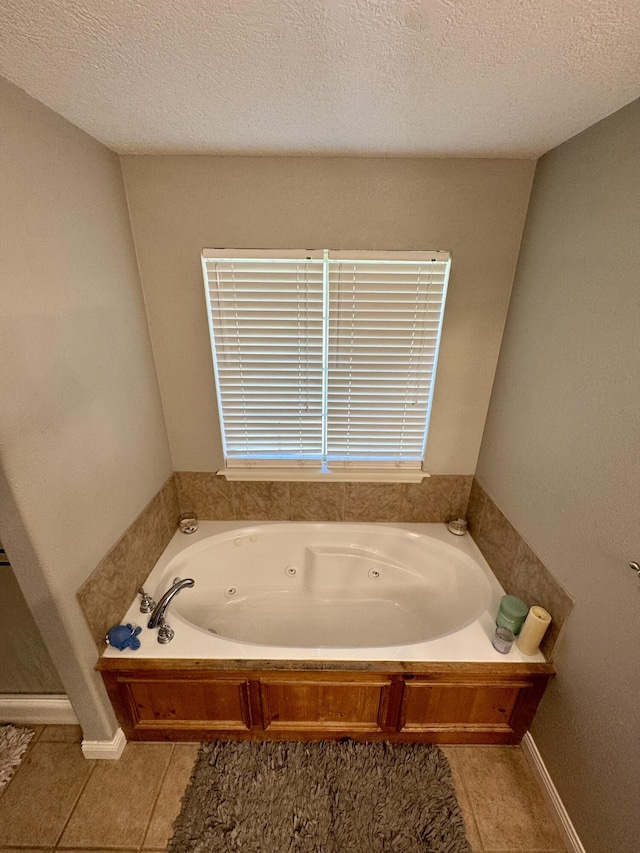 5537 S Pinehurst Ave, Springfield, MO 65810 - full bathroom with a jetted tub, tile patterned floors, and a textured ceiling