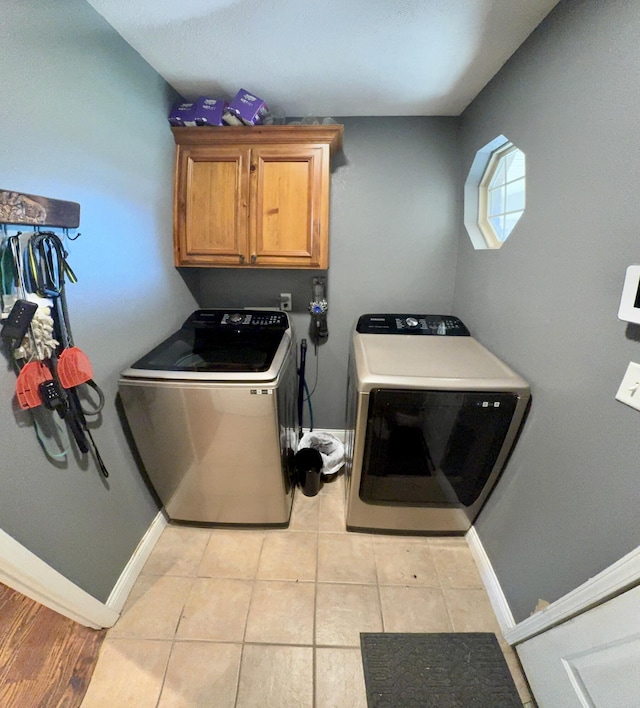 5537 S Pinehurst Ave, Springfield, MO 65810 - washroom with cabinet space, independent washer and dryer, and light tile patterned floors