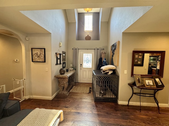 5537 S Pinehurst Ave, Springfield, MO 65810 - entrance foyer featuring arched walkways, dark wood finished floors, and a high ceiling