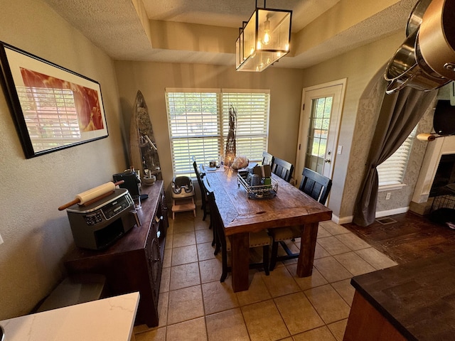 5537 S Pinehurst Ave, Springfield, MO 65810 - dining room featuring a textured ceiling, tile patterned floors, and a textured wall