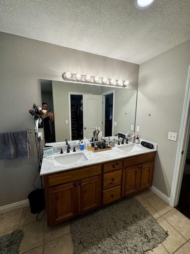 5537 S Pinehurst Ave, Springfield, MO 65810 - full bathroom with tile patterned flooring, double vanity, and a textured ceiling