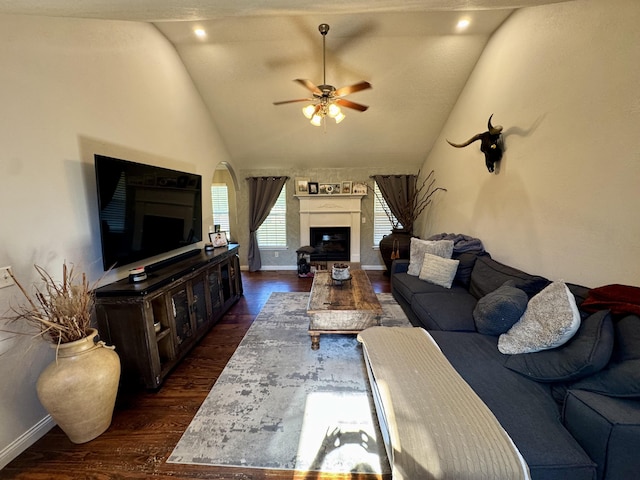 5537 S Pinehurst Ave, Springfield, MO 65810 - living area featuring lofted ceiling, a ceiling fan, dark wood-style flooring, and a fireplace with raised hearth