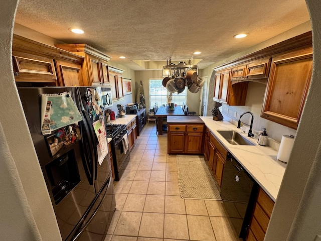 5537 S Pinehurst Ave, Springfield, MO 65810 - kitchen with black appliances, brown cabinetry, a textured ceiling, light tile patterned floors, and recessed lighting