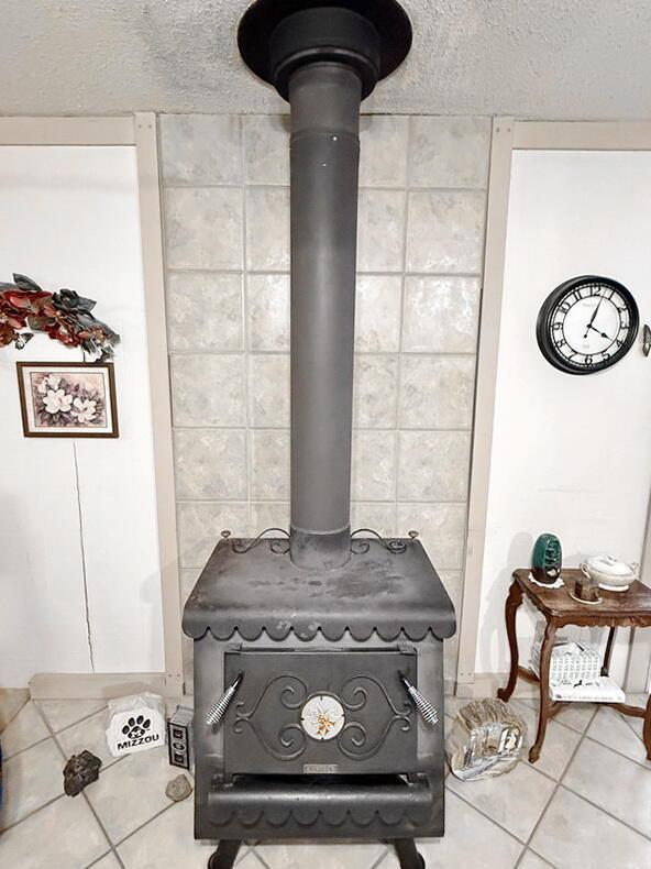 16610 S 1375th Rd, Nevada, MO 64772 - detailed view of a wood stove and a textured ceiling