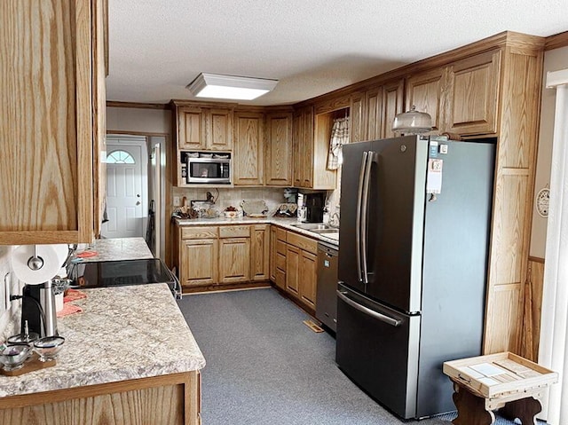 16610 S 1375th Rd, Nevada, MO 64772 - kitchen featuring stainless steel appliances, light countertops, dark carpet, a textured ceiling, and ornamental molding