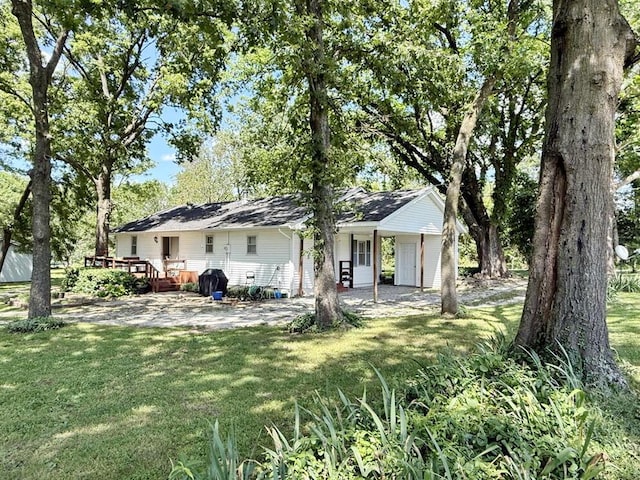 16610 S 1375th Rd, Nevada, MO 64772 - back of property with a yard and a wooden deck