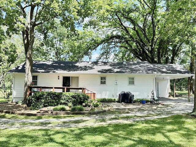 16610 S 1375th Rd, Nevada, MO 64772 - back of house with a wooden deck, an attached carport, and a lawn