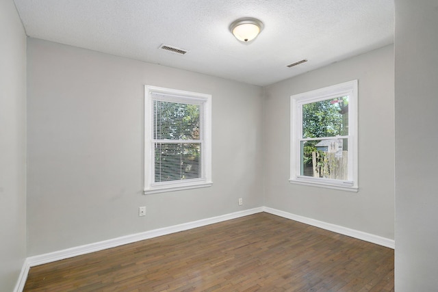 1739 S S Ave, Springfield, MO 65807 - spare room featuring dark wood-style floors and a textured ceiling