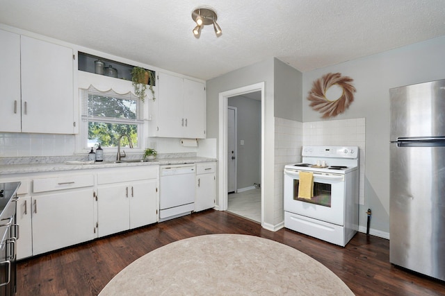 1739 S S Ave, Springfield, MO 65807 - kitchen featuring white appliances, dark wood finished floors, decorative backsplash, and light countertops