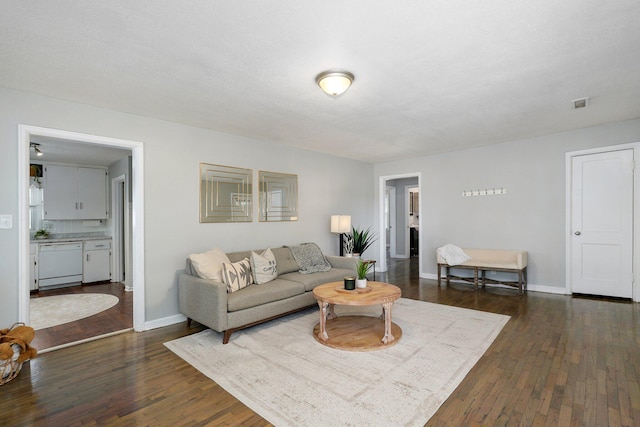 1739 S S Ave, Springfield, MO 65807 - living room featuring dark wood-style floors and baseboards