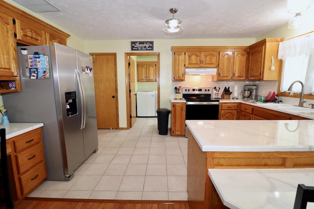 576 S Barnstable, Nixa, MO 65714 - kitchen featuring appliances with stainless steel finishes, washer / clothes dryer, under cabinet range hood, light countertops, and a textured ceiling