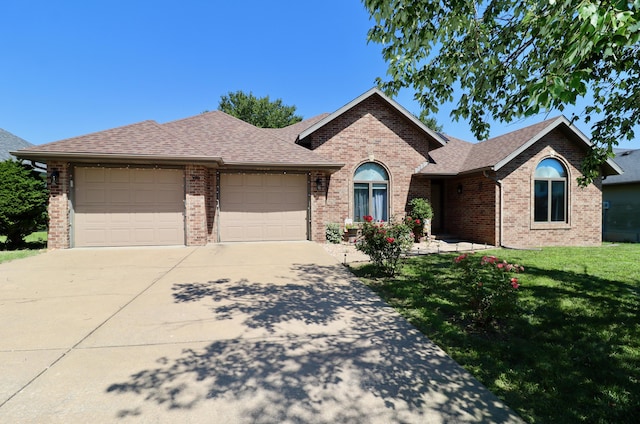 576 S Barnstable, Nixa, MO 65714 - ranch-style home featuring an attached garage, brick siding, driveway, a front yard, and roof with shingles