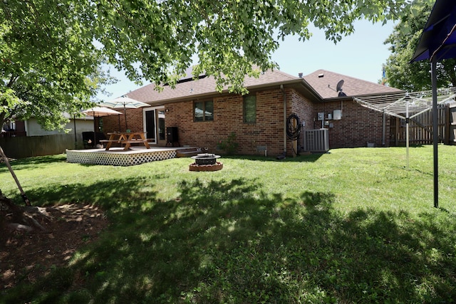 576 S Barnstable, Nixa, MO 65714 - rear view of house with a fire pit, brick siding, and a shingled roof