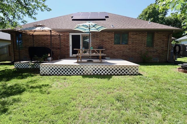 576 S Barnstable, Nixa, MO 65714 - rear view of property with a gazebo, roof mounted solar panels, a deck, a shingled roof, and brick siding