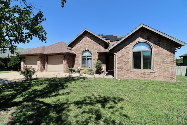 576 S Barnstable, Nixa, MO 65714 - ranch-style home featuring brick siding, solar panels, an attached garage, and concrete driveway
