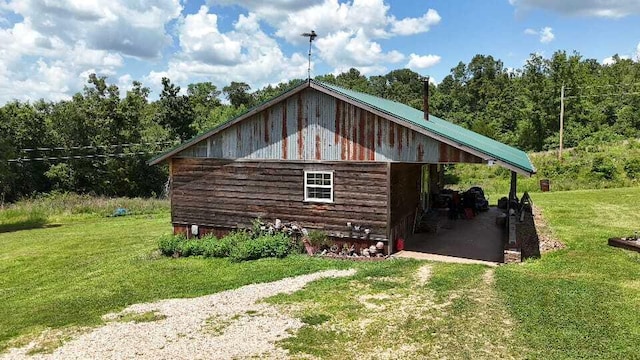 2240 Racetrack Hollow Rd, Anderson, MO 64831 - view of side of property with a lawn, driveway, a carport, a view of trees, and an outbuilding