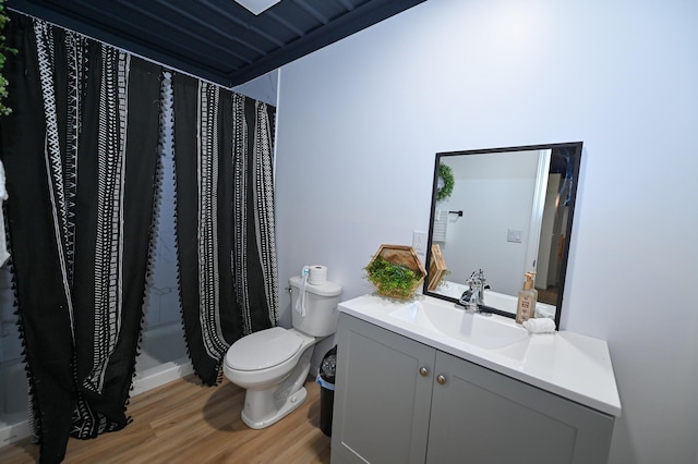 30950 E 54th Hwy, El Dorado Springs, MO 64744 - bathroom featuring wood finished floors, vanity, and a shower with curtain