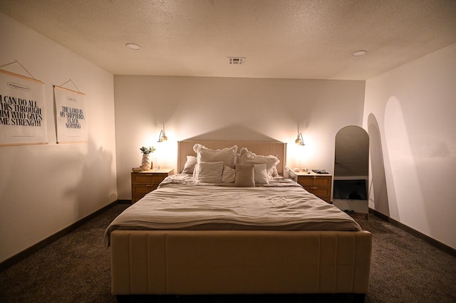 30950 E 54th Hwy, El Dorado Springs, MO 64744 - bedroom with dark colored carpet, arched walkways, and a textured ceiling