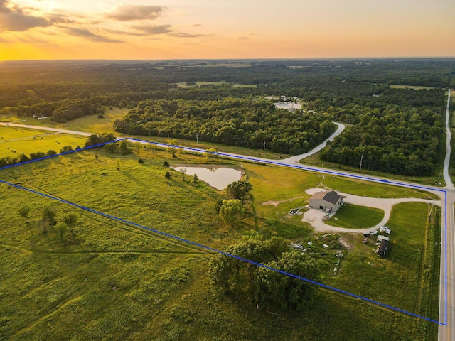 30950 E 54th Hwy, El Dorado Springs, MO 64744 - aerial view at dusk of property parcel outlined and a forest view