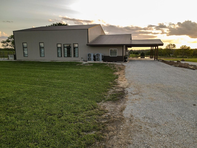 30950 E 54th Hwy, El Dorado Springs, MO 64744 - back of property featuring an attached carport, driveway, a yard, and a metal roof