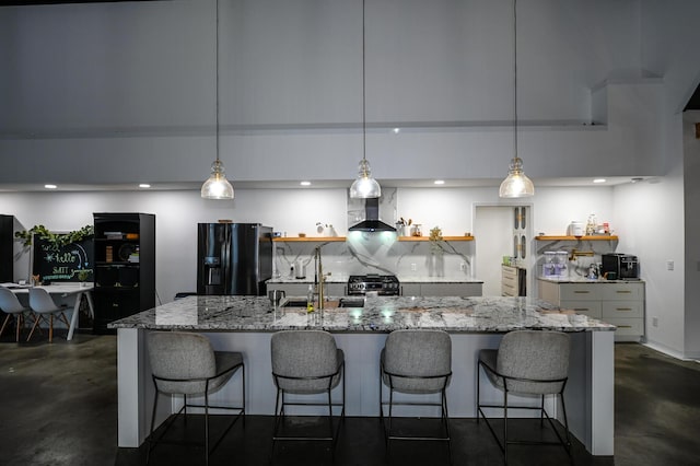 30950 E 54th Hwy, El Dorado Springs, MO 64744 - kitchen featuring black fridge, finished concrete floors, wall chimney exhaust hood, open shelves, and recessed lighting