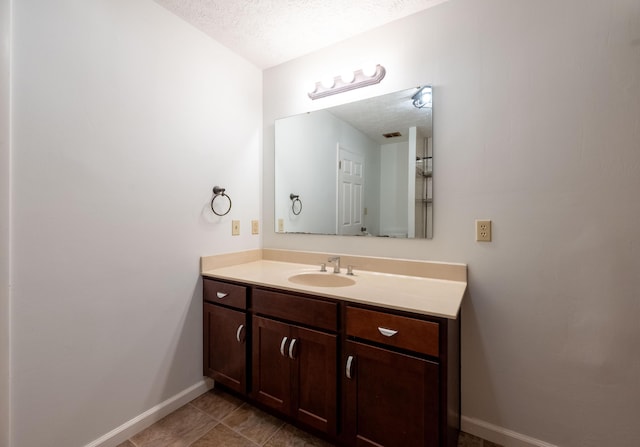 2924 S Roanoke Ave, Springfield, MO 65807 - bathroom with a textured ceiling, vanity, and tile patterned flooring