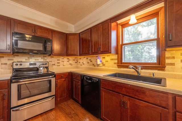 2924 S Roanoke Ave, Springfield, MO 65807 - kitchen featuring black appliances, a textured ceiling, light countertops, crown molding, and decorative backsplash