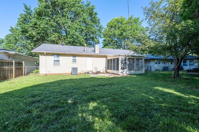 2924 S Roanoke Ave, Springfield, MO 65807 - rear view of property featuring a chimney, a fenced backyard, and a sunroom