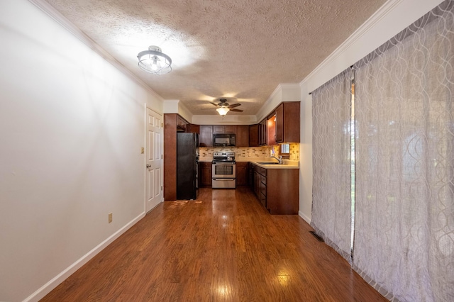 2924 S Roanoke Ave, Springfield, MO 65807 - kitchen featuring black appliances, ornamental molding, a textured ceiling, dark wood finished floors, and light countertops