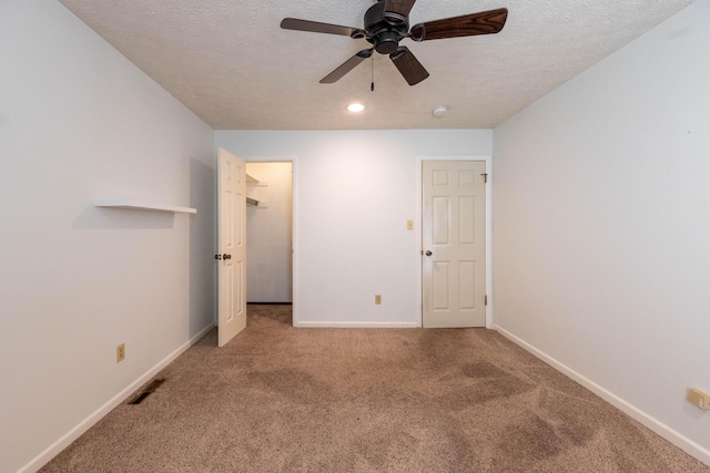 2924 S Roanoke Ave, Springfield, MO 65807 - unfurnished bedroom featuring carpet flooring, a spacious closet, a textured ceiling, ceiling fan, and recessed lighting