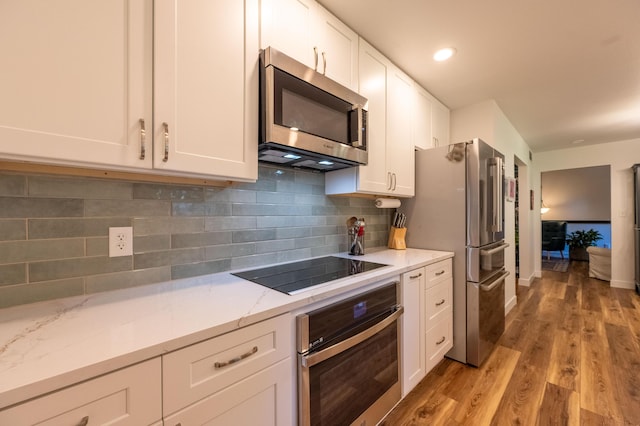 1728 E Camino Alto St, Springfield, MO 65804 - kitchen featuring stainless steel appliances, white cabinets, light wood finished floors, and light stone countertops