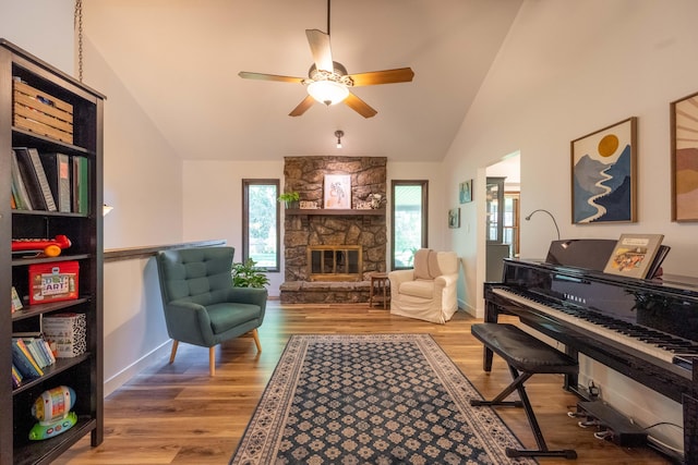 1728 E Camino Alto St, Springfield, MO 65804 - living area featuring ceiling fan, wood finished floors, a stone fireplace, and high vaulted ceiling