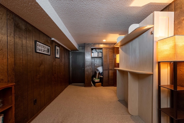 1728 E Camino Alto St, Springfield, MO 65804 - hall featuring wooden walls, carpet flooring, and a textured ceiling