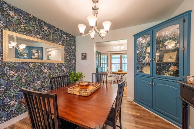 1728 E Camino Alto St, Springfield, MO 65804 - dining room featuring wallpapered walls, a chandelier, and wood finished floors
