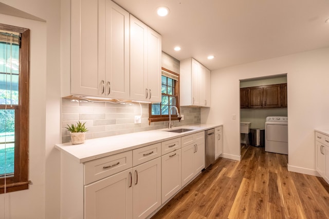 1728 E Camino Alto St, Springfield, MO 65804 - kitchen with washer / clothes dryer, dishwasher, light wood-style floors, white cabinets, and tasteful backsplash