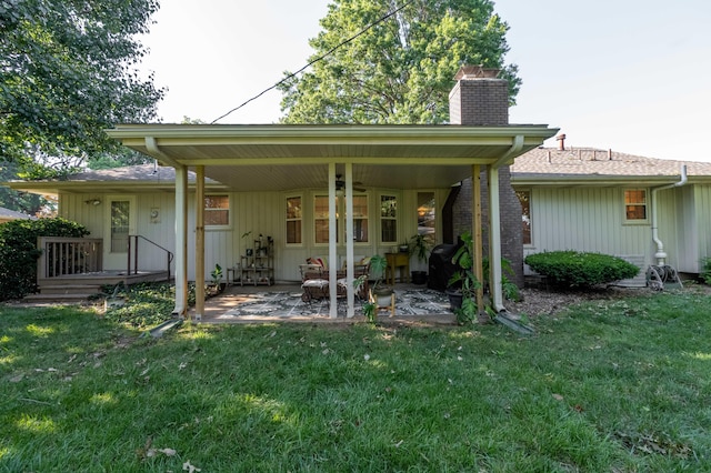 1728 E Camino Alto St, Springfield, MO 65804 - rear view of property featuring a chimney, a yard, and a patio
