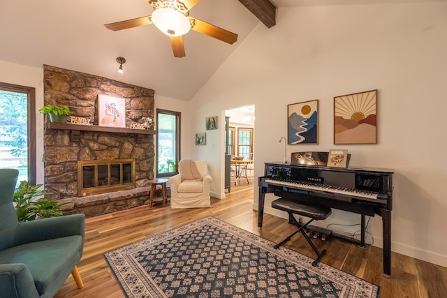 1728 E Camino Alto St, Springfield, MO 65804 - living room with wood finished floors, beamed ceiling, a ceiling fan, a stone fireplace, and high vaulted ceiling