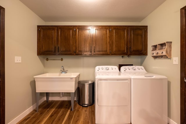 1728 E Camino Alto St, Springfield, MO 65804 - laundry room featuring cabinet space, washer and clothes dryer, and wood finished floors