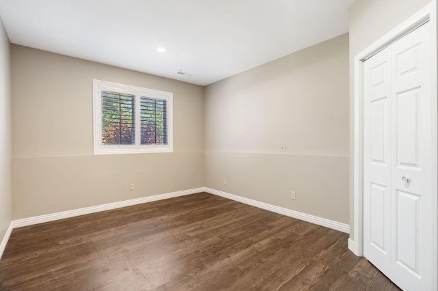 1545 N Oakfair Pl, Springfield, MO 65802 - unfurnished bedroom with dark wood finished floors, a closet, and recessed lighting