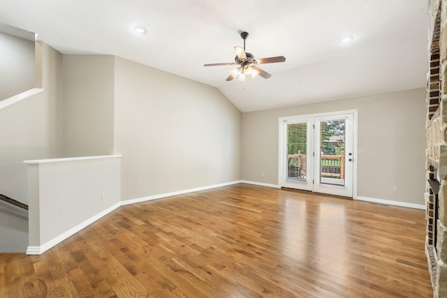 1545 N Oakfair Pl, Springfield, MO 65802 - unfurnished living room featuring a brick fireplace, a ceiling fan, wood finished floors, vaulted ceiling, and recessed lighting