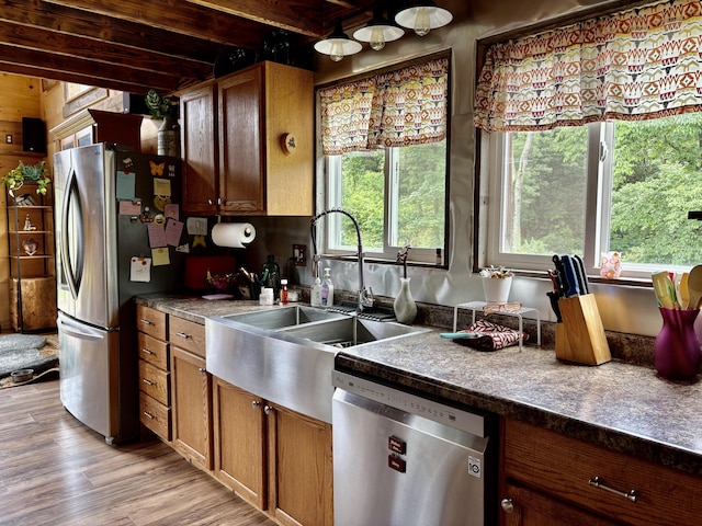 421 N Emory Creek Rd, Walnut Shade, MO 65771 - kitchen featuring appliances with stainless steel finishes, beamed ceiling, light wood-type flooring, dark countertops, and brown cabinets