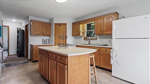 2005 Debra Dr, West Plains, MO 65775 - kitchen featuring freestanding refrigerator, light countertops, a center island, and brown cabinets
