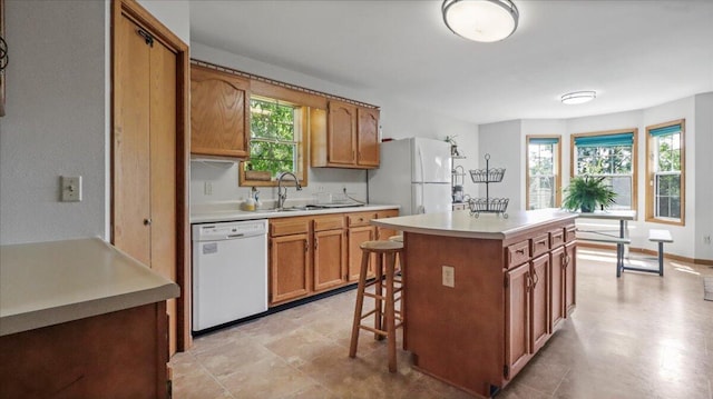 2005 Debra Dr, West Plains, MO 65775 - kitchen with white appliances, light countertops, healthy amount of natural light, and a kitchen island