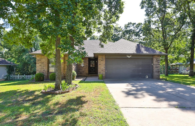 3723 N Vera Cruz Dr, Springfield, MO 65803 - view of front of property with brick siding, an attached garage, driveway, and a shingled roof