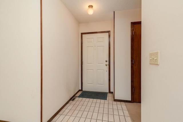 3723 N Vera Cruz Dr, Springfield, MO 65803 - entryway featuring a textured ceiling and baseboards