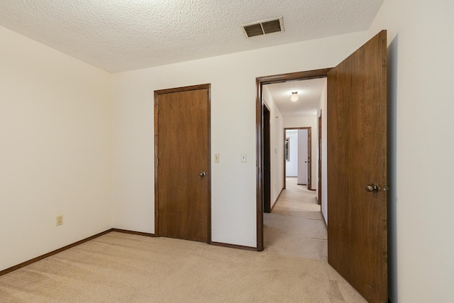 3723 N Vera Cruz Dr, Springfield, MO 65803 - unfurnished bedroom featuring light colored carpet and a textured ceiling