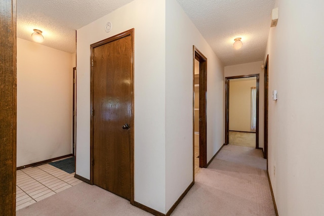 3723 N Vera Cruz Dr, Springfield, MO 65803 - hall featuring a textured ceiling and light carpet