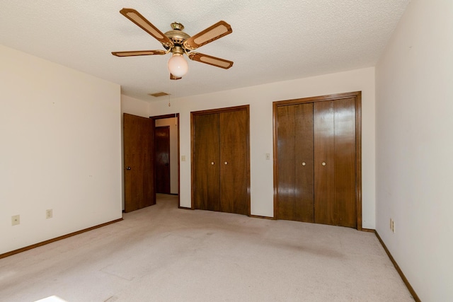 3723 N Vera Cruz Dr, Springfield, MO 65803 - unfurnished bedroom featuring light colored carpet, two closets, and a ceiling fan