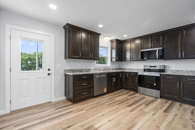 407 W Adamson St, Miller, MO 65707 - kitchen featuring stainless steel appliances, light wood-style floors, dark brown cabinetry, and recessed lighting