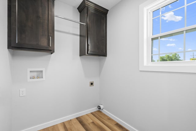 407 W Adamson St, Miller, MO 65707 - laundry room with electric dryer hookup, light wood-type flooring, hookup for a washing machine, and cabinet space